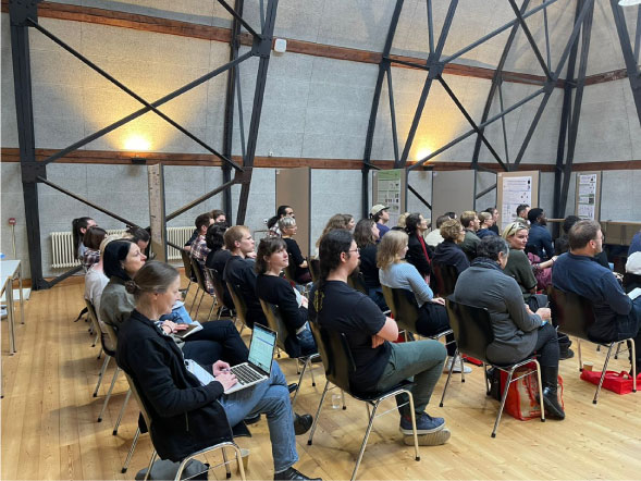 People seated and facing a screen during a BPM event