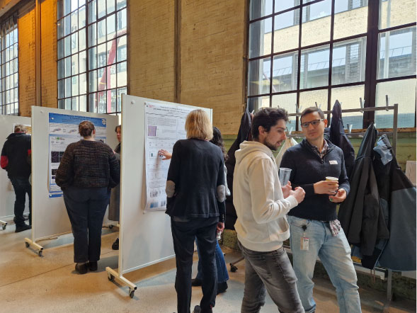 People discussing posters during a poster session