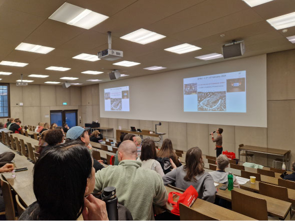 People seated and facing a screen during a BPM event